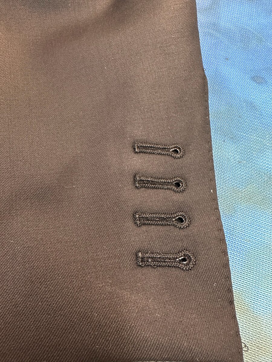 Buttonholes on brown cloth